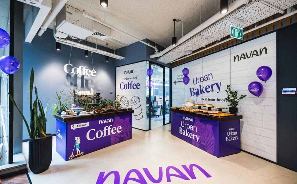 Office café with wrapped coffee and bakery counters, printed wall graphics and a large floor decal